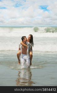 Young beautiful couple in love on a sunny beach