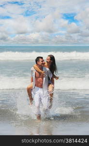 Young beautiful couple in love on a sunny beach