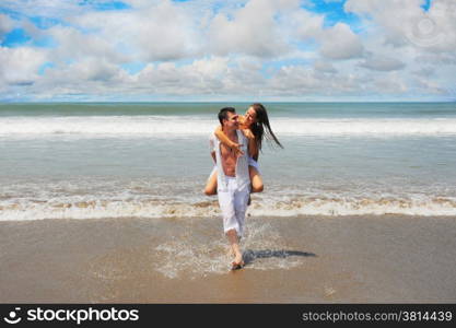 Young beautiful couple in love on a sunny beach