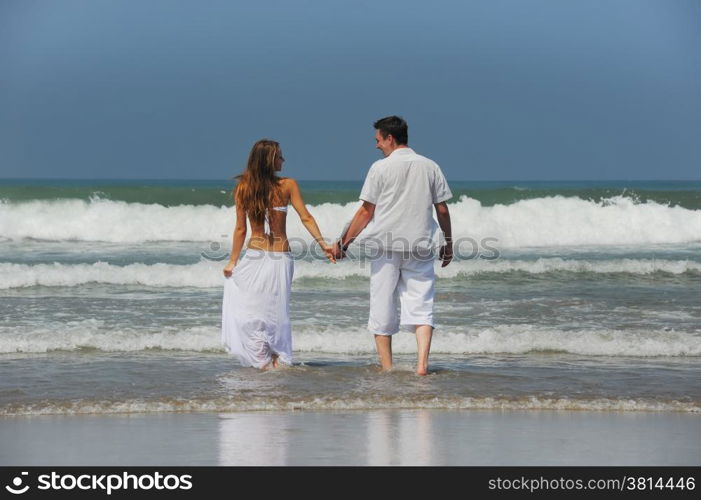 Young beautiful couple in love on a sunny beach