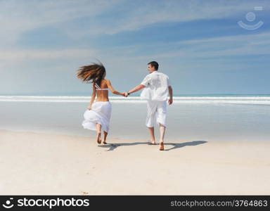 Young beautiful couple on a sunny beach