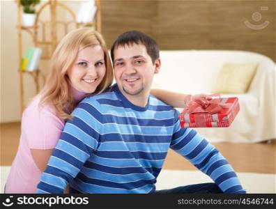 young beautiful couple together with a present