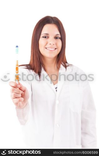 Young beautiful dentist holding a toothbrush - oral hygiene concept