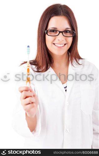Young beautiful dentist holding a toothbrush - oral hygiene concept