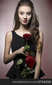 Young, beautiful, elegant girl with lice make up in black dess is holding valentine&rsquo;s present like rose and heart.