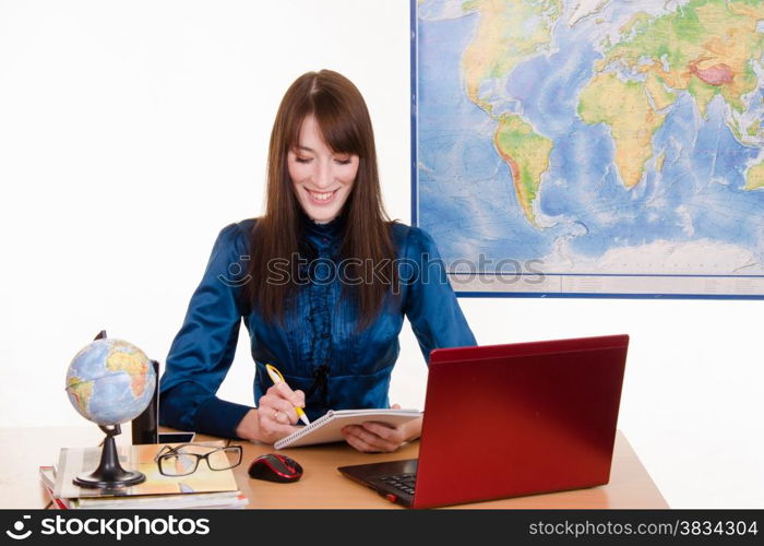 Young beautiful employee in the office of the travel agency