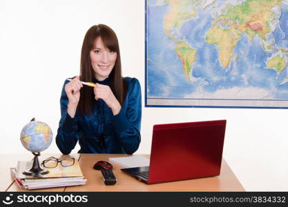 Young beautiful employee in the office of the travel agency