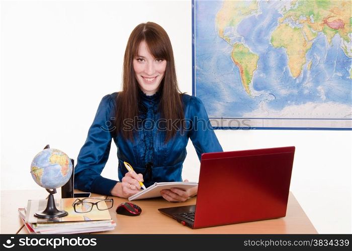 Young beautiful employee in the office of the travel agency