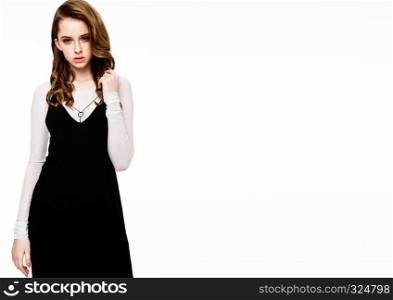 Young beautiful fashion model wearing black dress with white shirt on white background