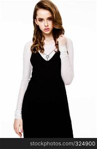Young beautiful fashion model wearing black dress with white shirt on white background