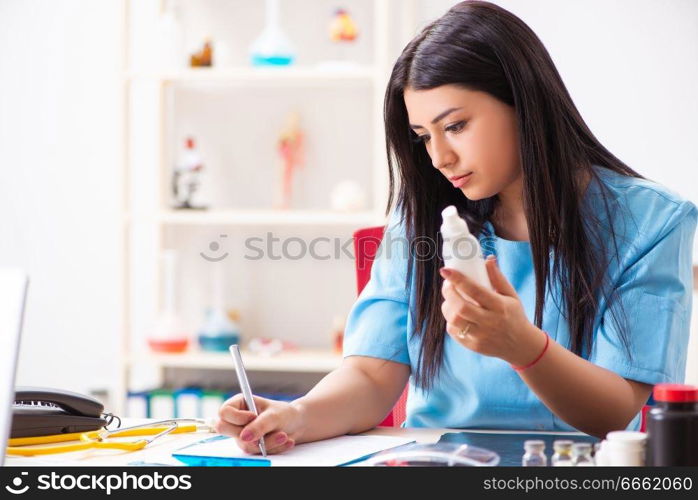 Young beautiful female doctor working in the clinic 