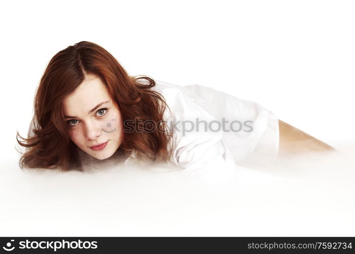 Young beautiful girl close up on the heaven cloud, fog, mist. Studio isolated on white background. Heaven girl on cloud