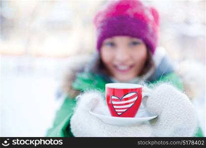 young beautiful girl day dreaming outdoors in winter while having coffee