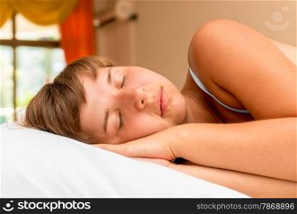 young beautiful girl has a rest tired in bed