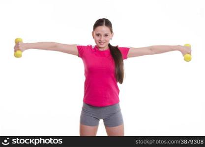 Young beautiful girl holds Europeans physical exercise. Sportswoman stretched both arms with dumbbells