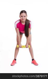 Young beautiful girl holds Europeans physical exercise. The athlete performs a forward bends with dumbbells