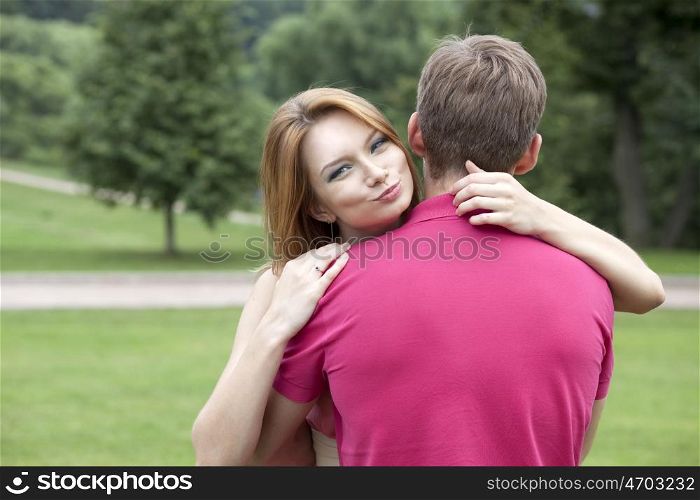Young beautiful girl hugging her favorite guy