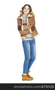 Young beautiful girl in a leather sheepskin coat and blue jeans isolated on white background