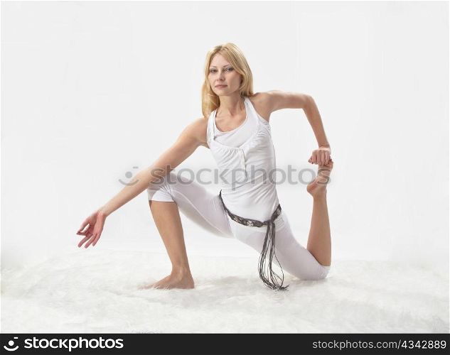 Young beautiful girl is professionally engaged in yoga