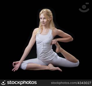 Young beautiful girl is professionally engaged in yoga