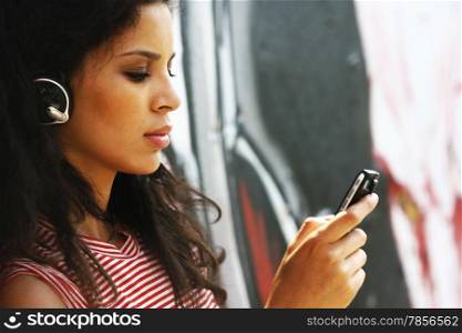 Young beautiful girl listening to MP3 player