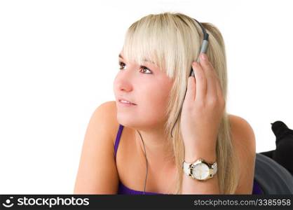 Young beautiful girl lying on the floor listening to music. Over white background