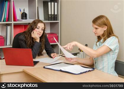 Young beautiful girl on reception at the office specialist. Young girl shows the errors in the documents office staff