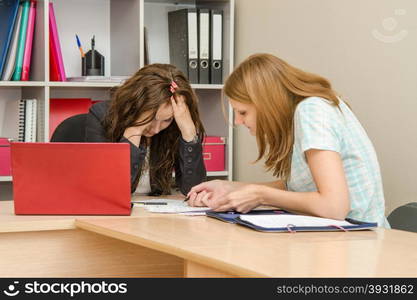 Young beautiful girl on reception at the office specialist. Office worker was tired of the problems visitors office