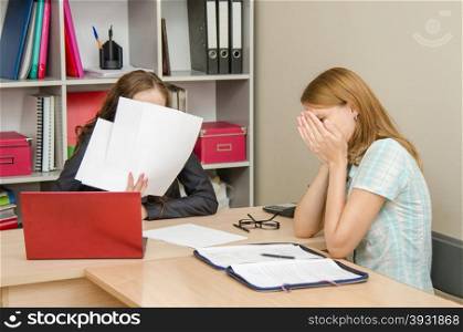 Young beautiful girl on reception at the office specialist. The girl was crying at the reception office worker covered his face with papers