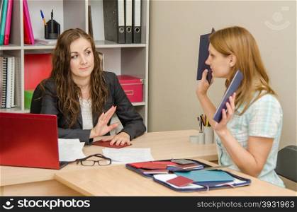 Young beautiful girl on reception at the office specialist. Girl shows HR specialist diplomas which she does not want to look