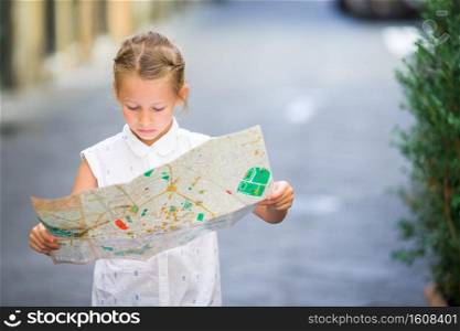 Young beautiful girl on steps with city map in Rome. Italy. Adorable little girl enjoy italian vacation holiday in Europe.