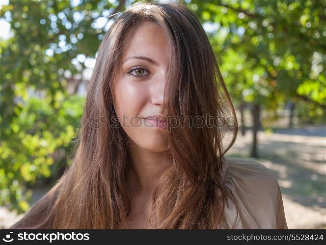 Young beautiful girl outdoors face closeup