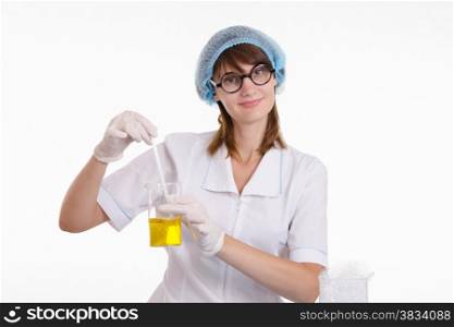 Young beautiful girl posing chemical experiments in the laboratory