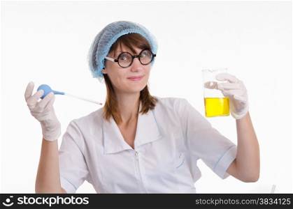 Young beautiful girl posing chemical experiments in the laboratory