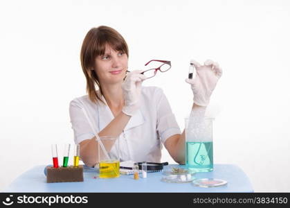 Young beautiful girl posing chemical experiments in the laboratory