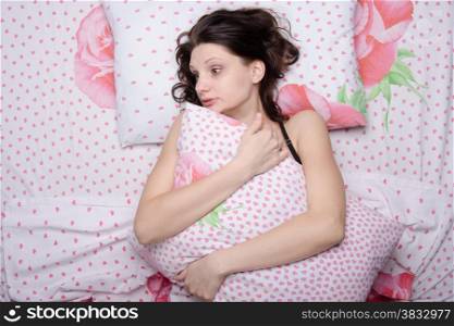 Young beautiful girl sleeping alone in bed