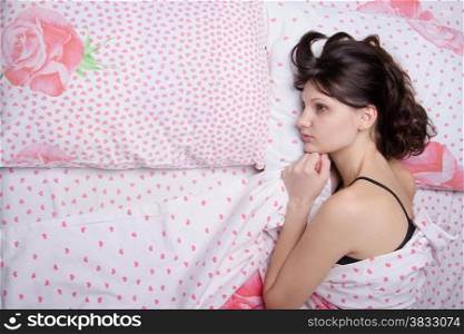 Young beautiful girl sleeping alone in bed