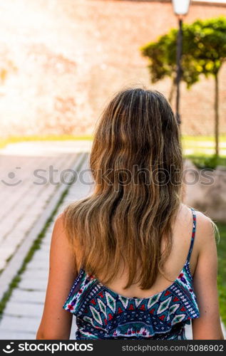 Young beautiful girl visiting the citadel of Alba Iulia, Romania.