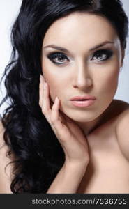 Young beautiful girl with makeup and hair on white background