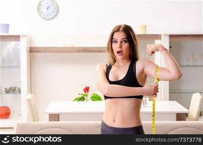 Young beautiful girl with tape meter in dieting concept