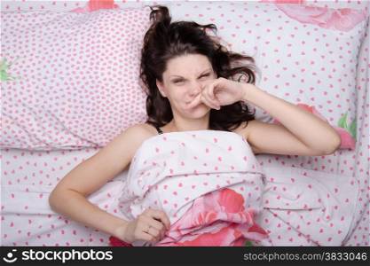 Young beautiful girl woke up alone in bed