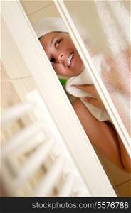 Young beautiful happy smiling tanned brunett woman at shower in bathroom