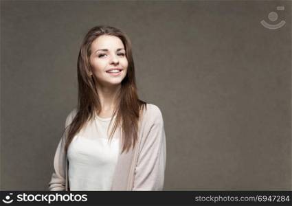 Young beautiful happy woman in casual cloths against wall. Young beautiful happy woman in casual cloths against wall.