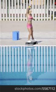 young beautiful healthy woman exercise fitness and stepping at swimming pool