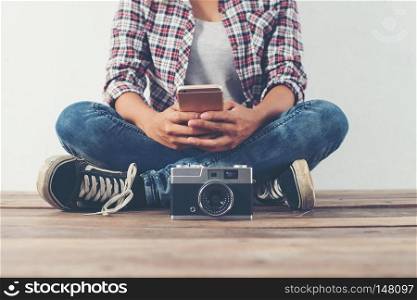 Young beautiful hipster woman with an old retro camera.