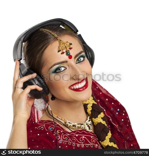 Young beautiful Indian woman listening to music on headphones