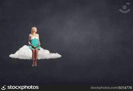 Young beautiful lady sitting on cloud with book in hands. Girl with book