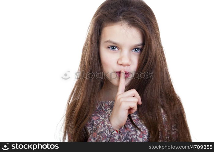 Young beautiful Little girl has put forefinger to lips as sign of silence