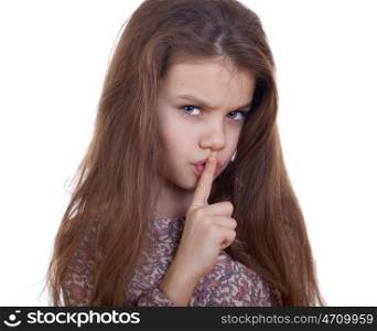 Young beautiful Little girl has put forefinger to lips as sign of silence