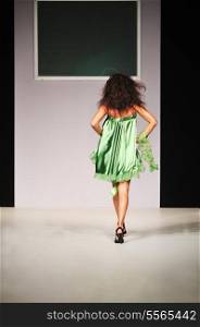 young beautiful model walking on fashion show piste